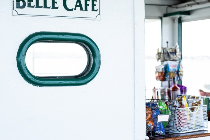 Exterior view of Belle Café with a small service window and green accents.