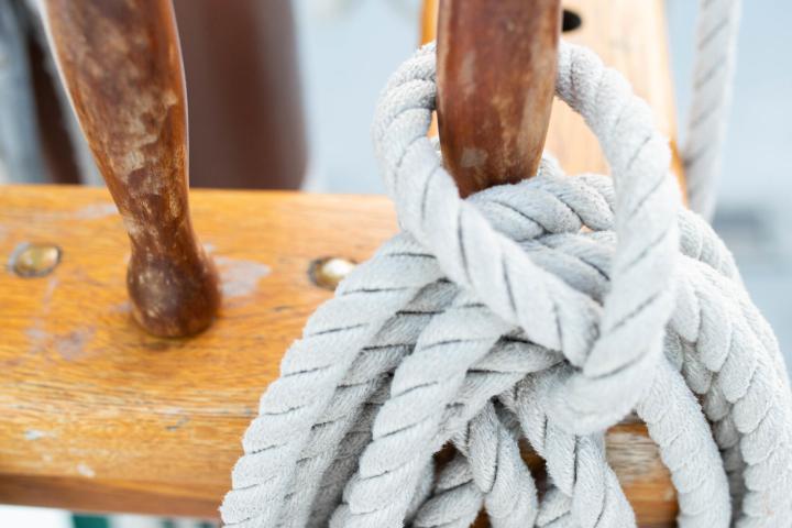 Coiled rope on a wooden peg on a ship's deck
