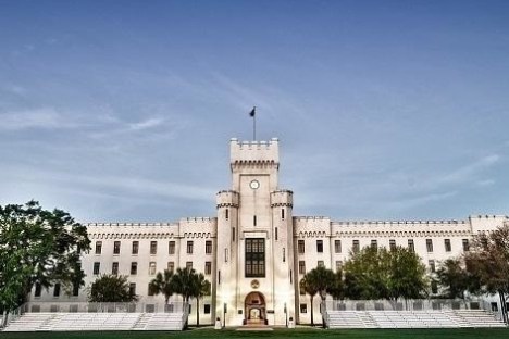Front view of a large white fortress-like building with a central tower and symmetrical design.